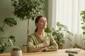 Person holding sage green card with ClarIThrive logo